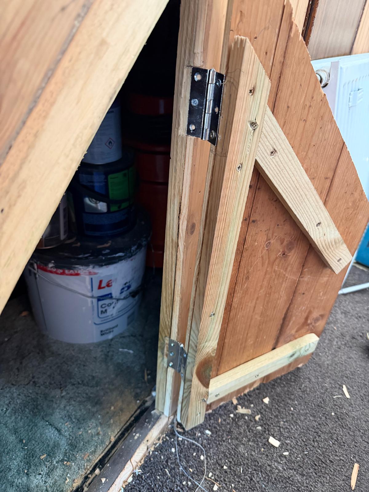 A wooden outdoor storage cupboard part way through being built.