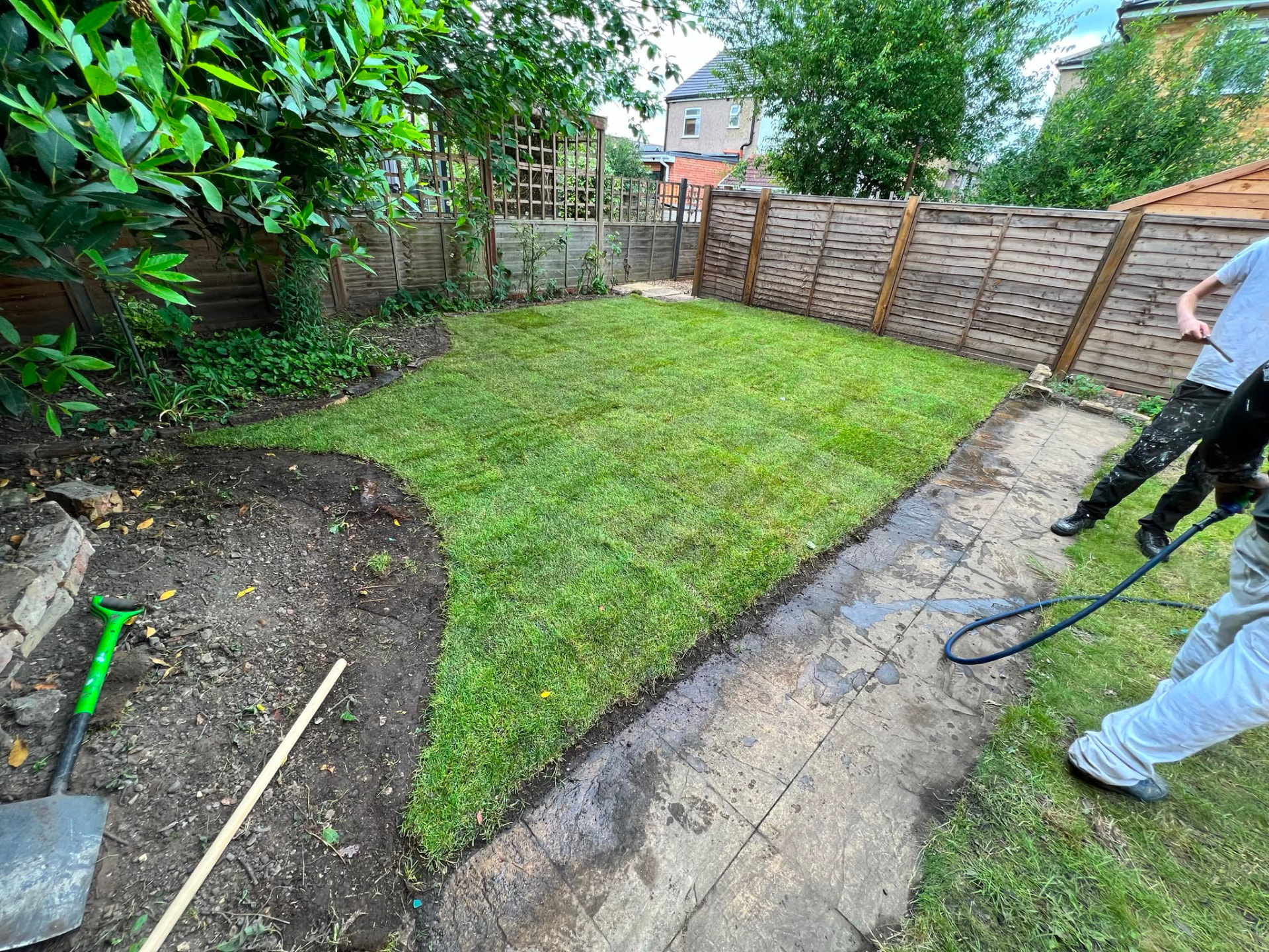 A garden with a newly installed artificial lawn.