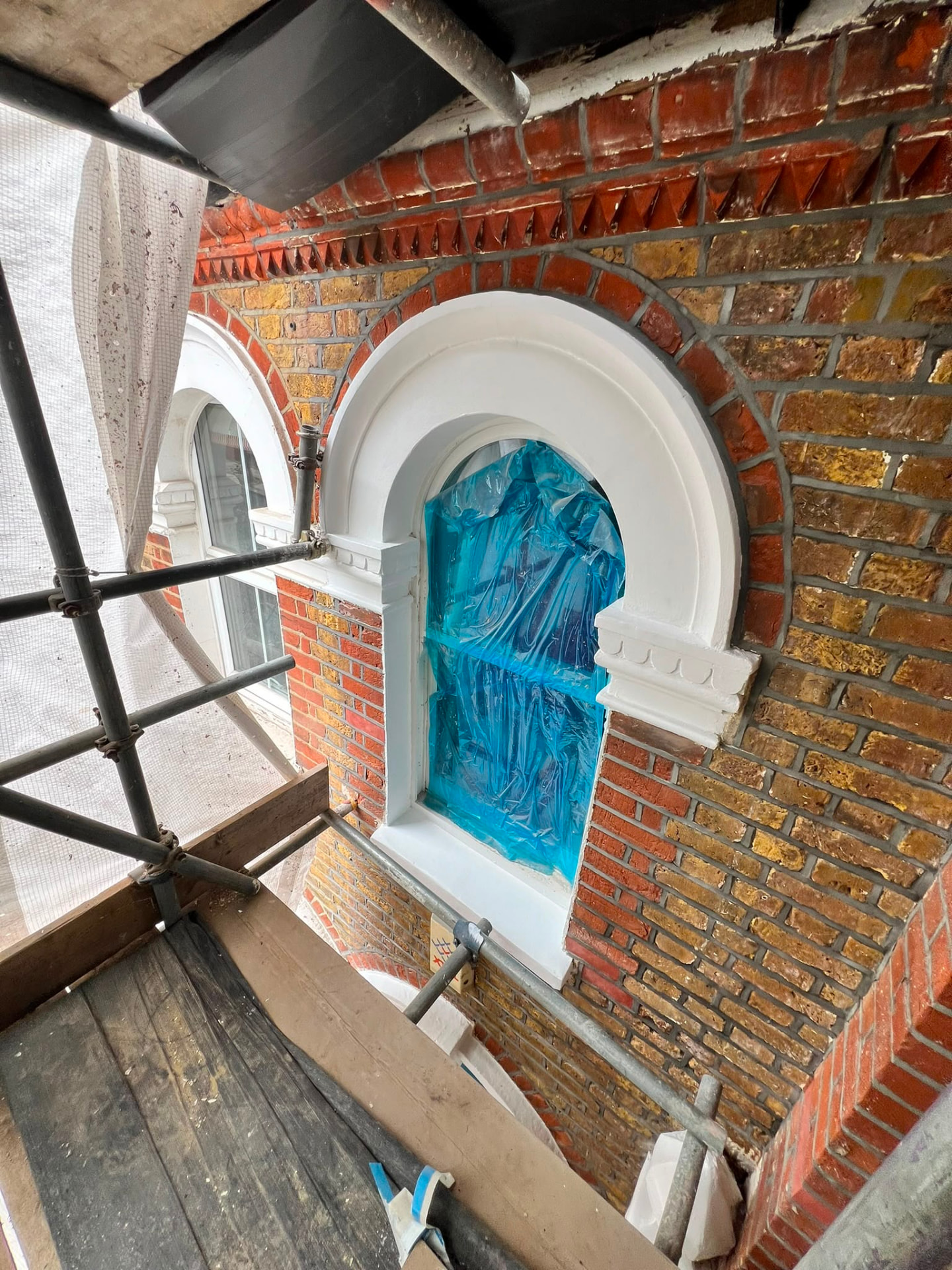 After: the exterior arched window frame decorated in crisp white.
